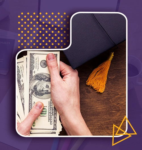 Hands holding US dollar bills beside a graduation cap, representing paying a university tuition deposit